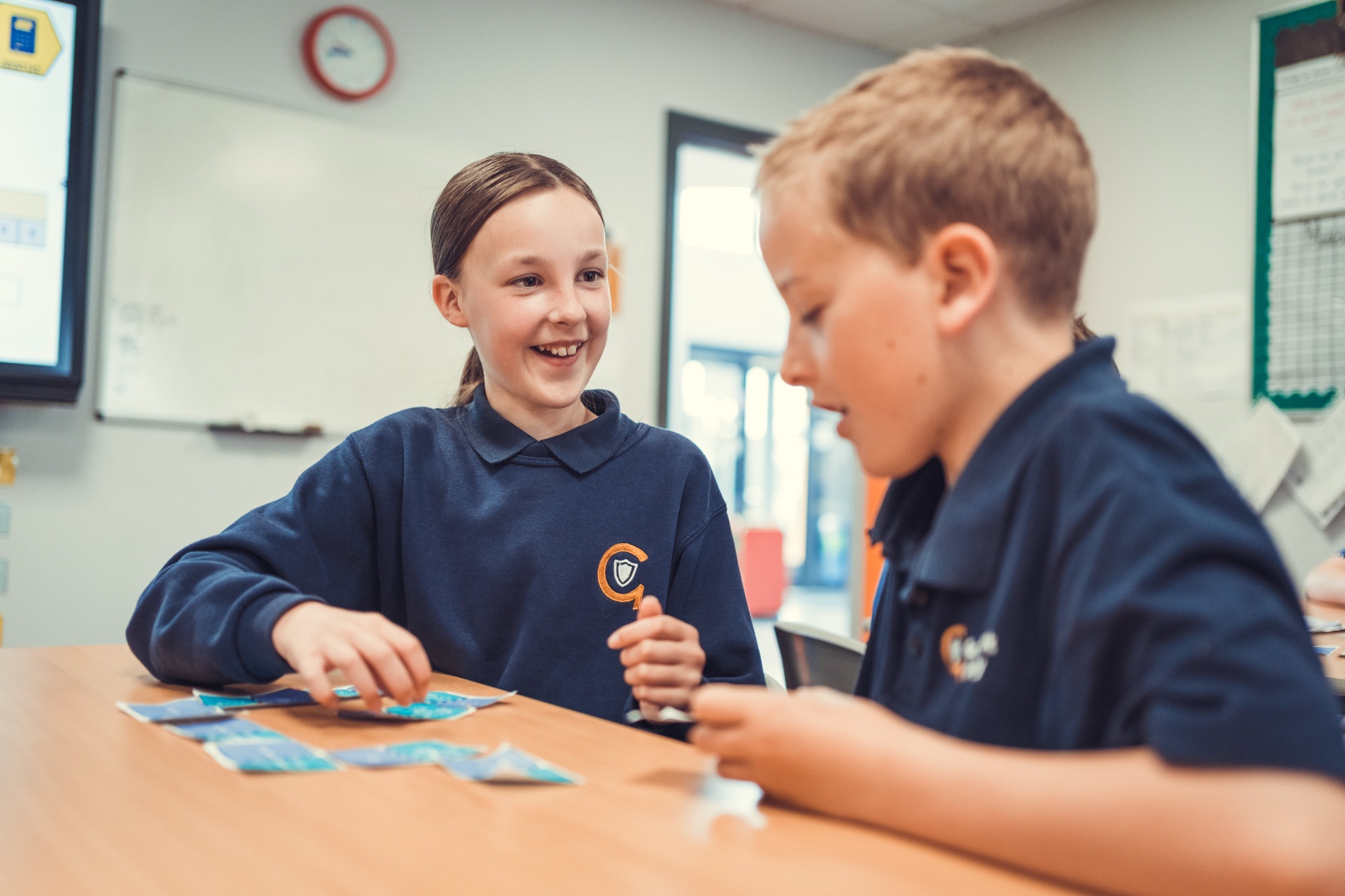 Children working on a task together in the classroom